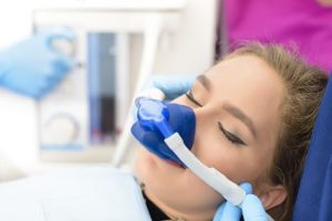 Woman receiving nitrous sedation during dental procedures to alleviate dental phobia (dental fear)